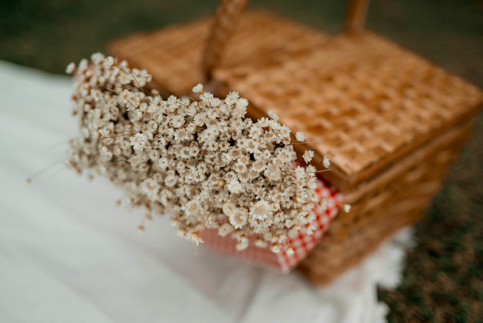 A bouquet of small, delicate white flowers, possibly baby's breath, arranged loosely with visible green stems. The flowers are fresh, with textured petals and consistent color, and are held together i